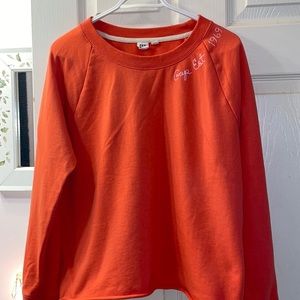 Long sleeve Gap sweat shirt with un-hemmed  edge waist. Size L. Bright orange